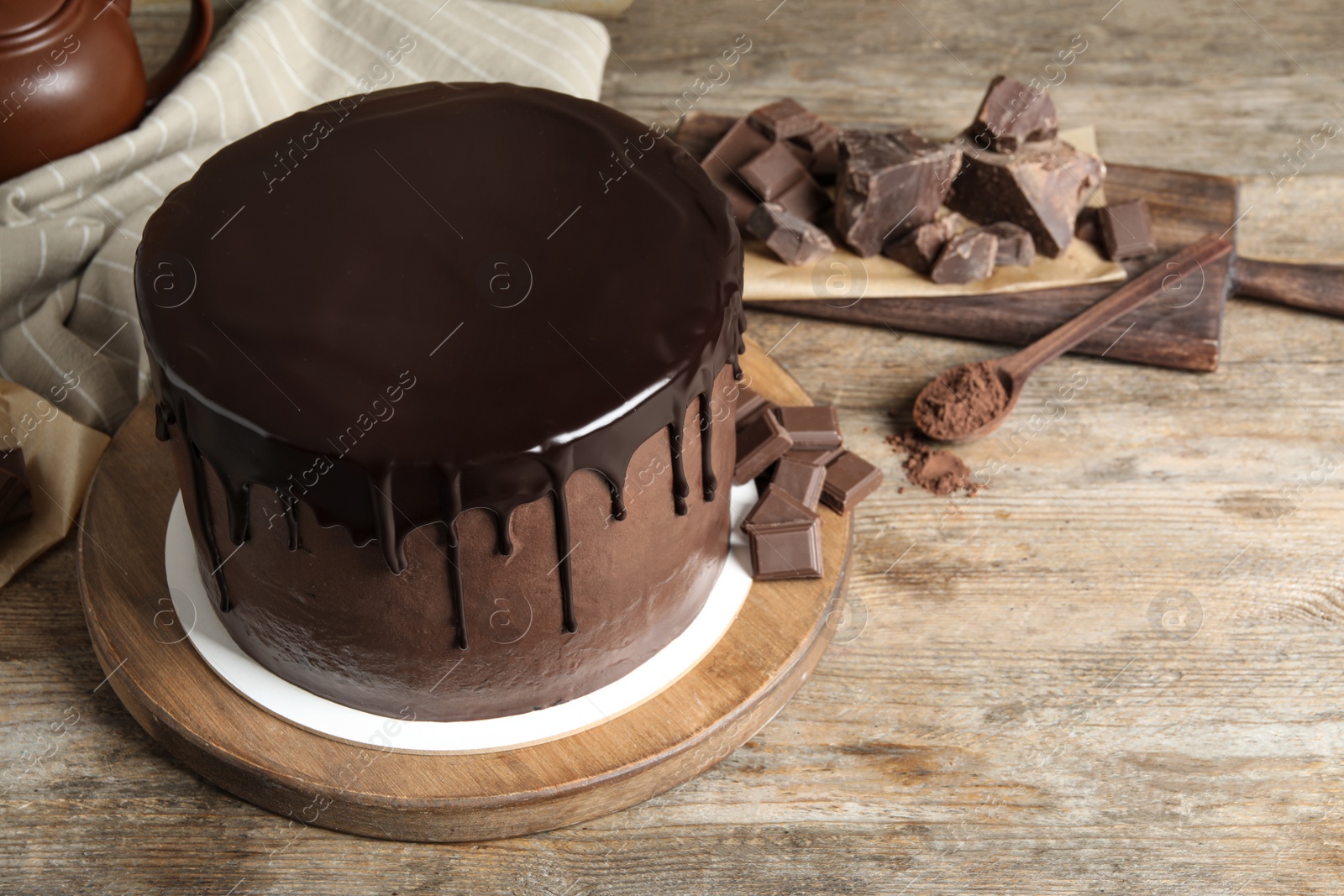 Photo of Freshly made delicious chocolate cake on wooden table. Space for text