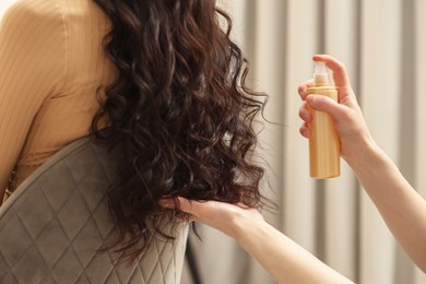 Hair styling. Professional hairdresser working with client indoors, closeup