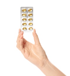 Photo of Woman holding pills in blister pack on white background, closeup