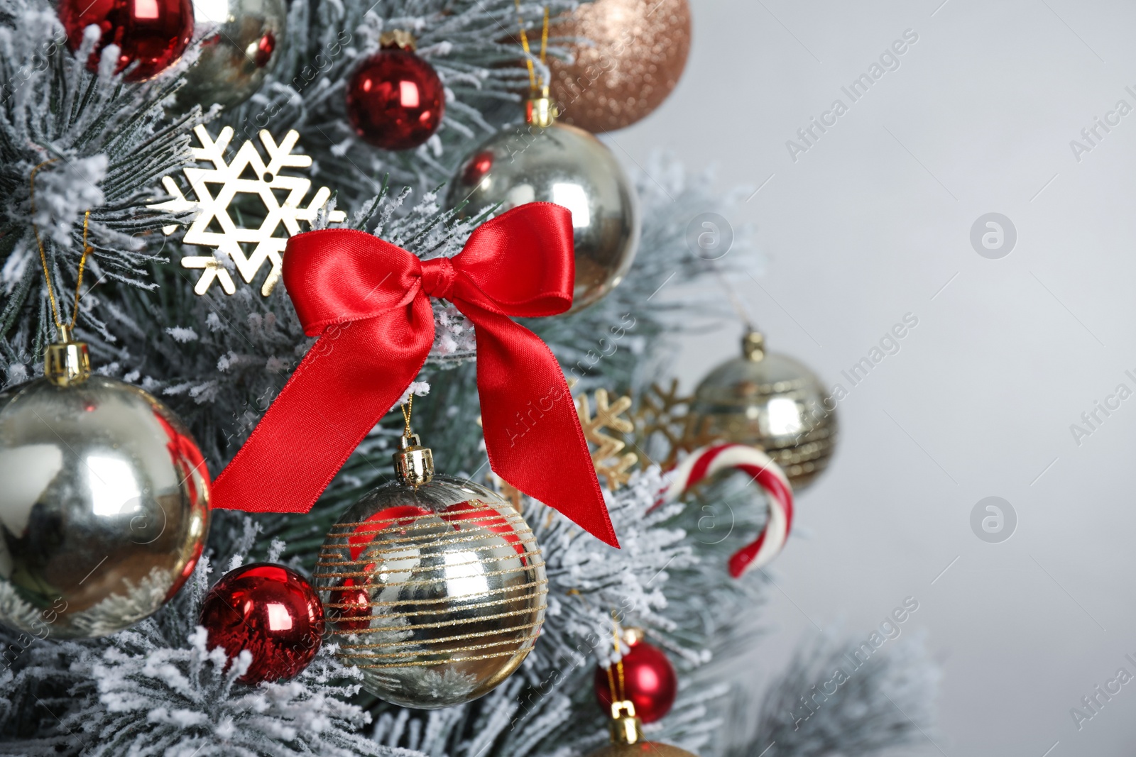 Photo of Beautiful Christmas tree with decor against light grey background, closeup. Space for text