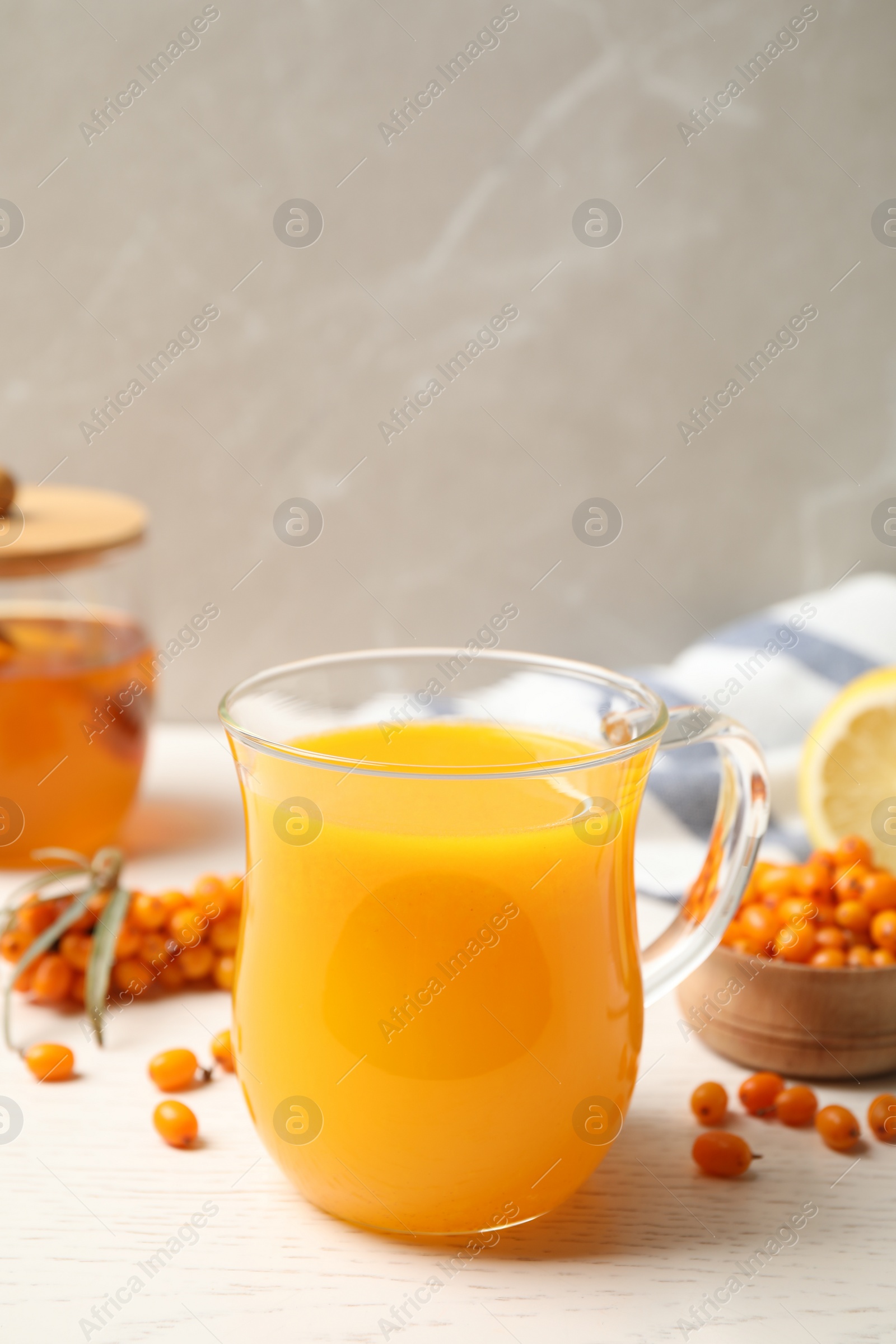 Photo of Fresh sea buckthorn tea on white wooden table