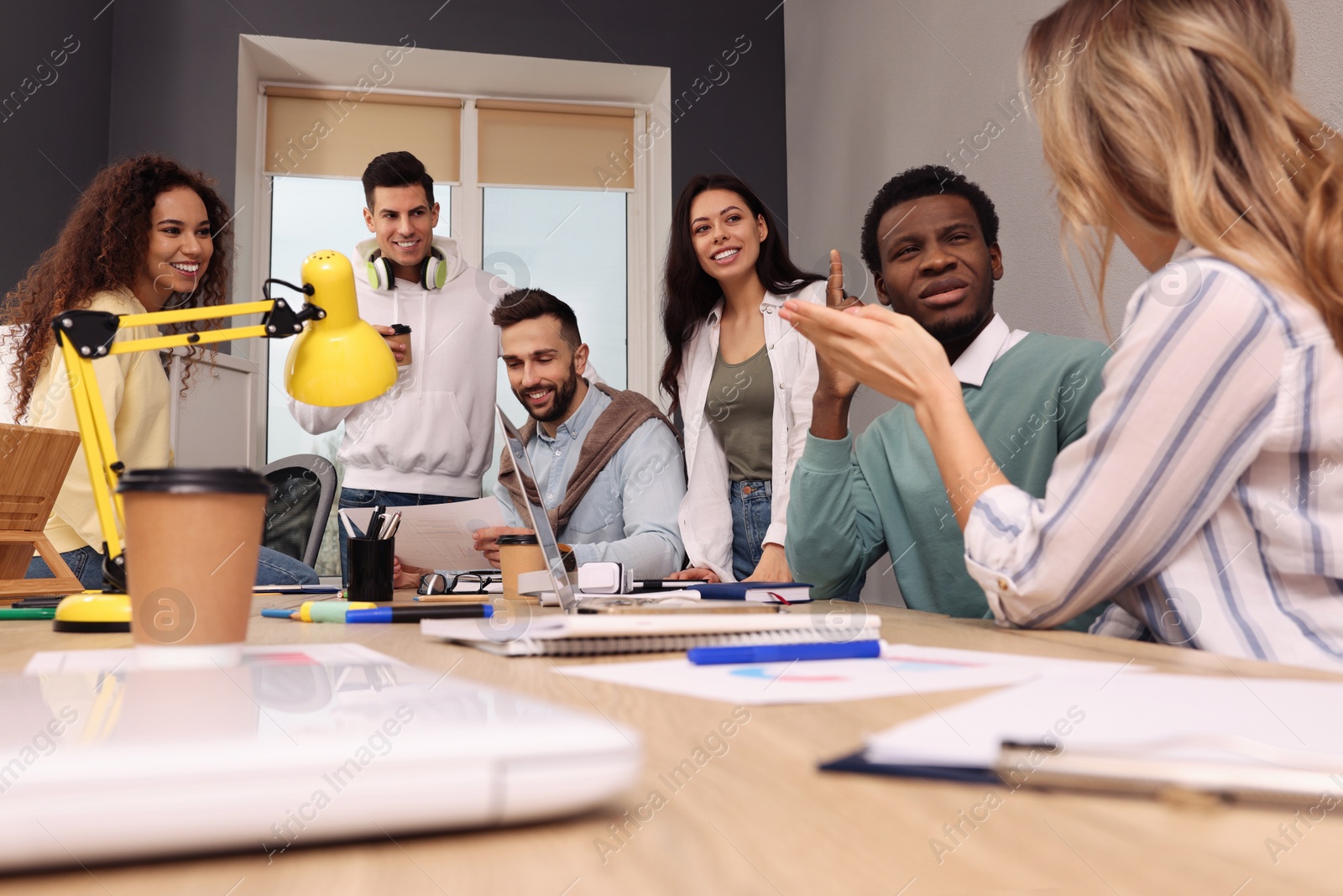 Photo of Team of employees working together in office. Startup project