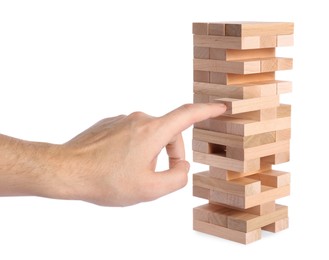 Photo of Playing Jenga. Man building tower with wooden blocks on white background, closeup