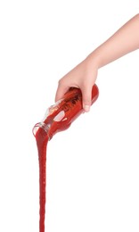 Photo of Woman pouring tasty ketchup from bottle isolated on white, closeup