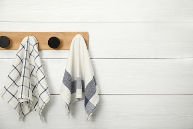 Clean kitchen towels hanging on rack. Space for text