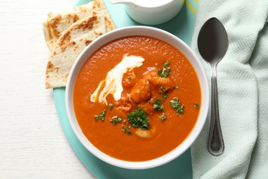 Photo of Delicious butter chicken served on table, top view. Traditional Murgh Makhani dish