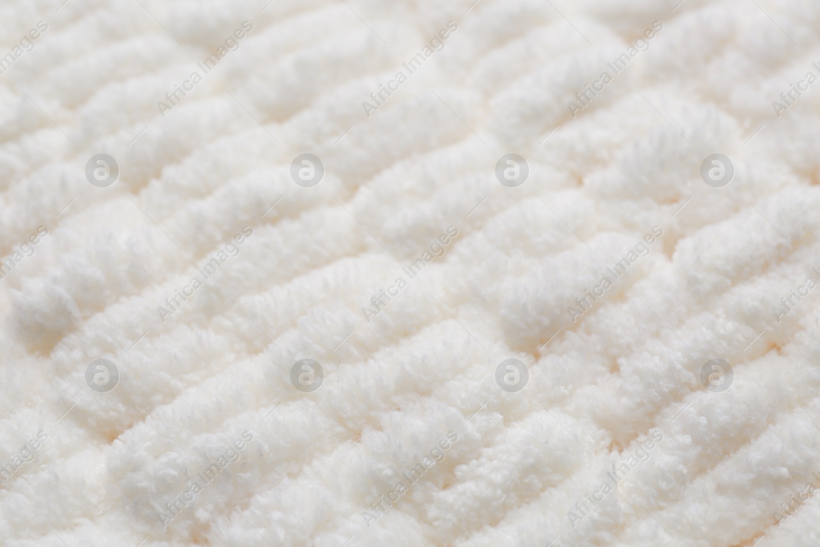 Photo of Soft white knitted fabric as background, closeup