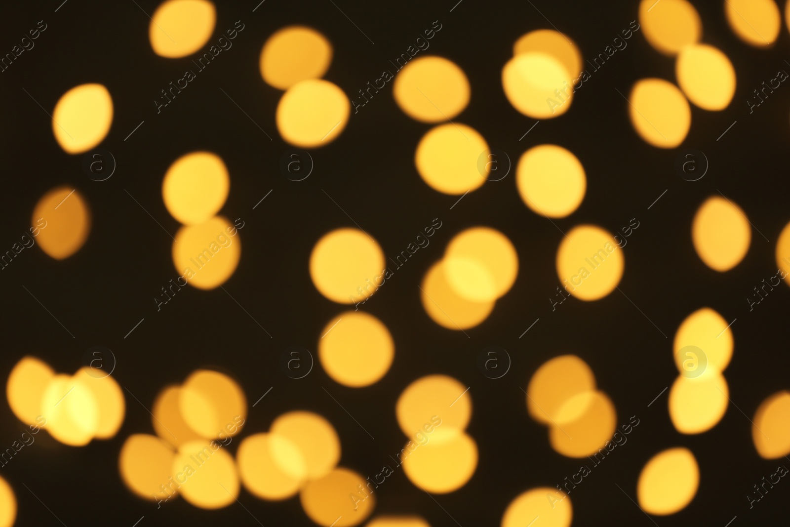 Photo of Beautiful golden lights on dark background. Bokeh effect