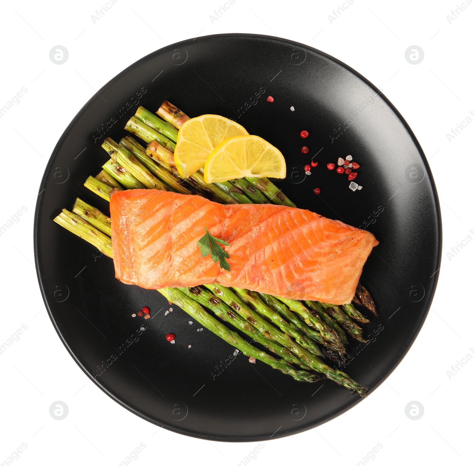 Photo of Tasty grilled salmon with asparagus, lemon and spices isolated on white, top view