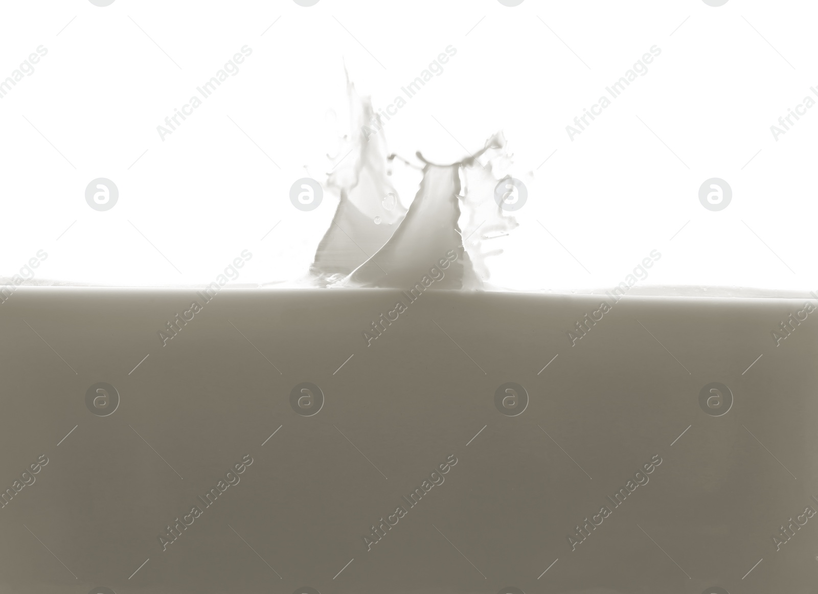 Photo of Fresh milk with splash isolated on white, closeup