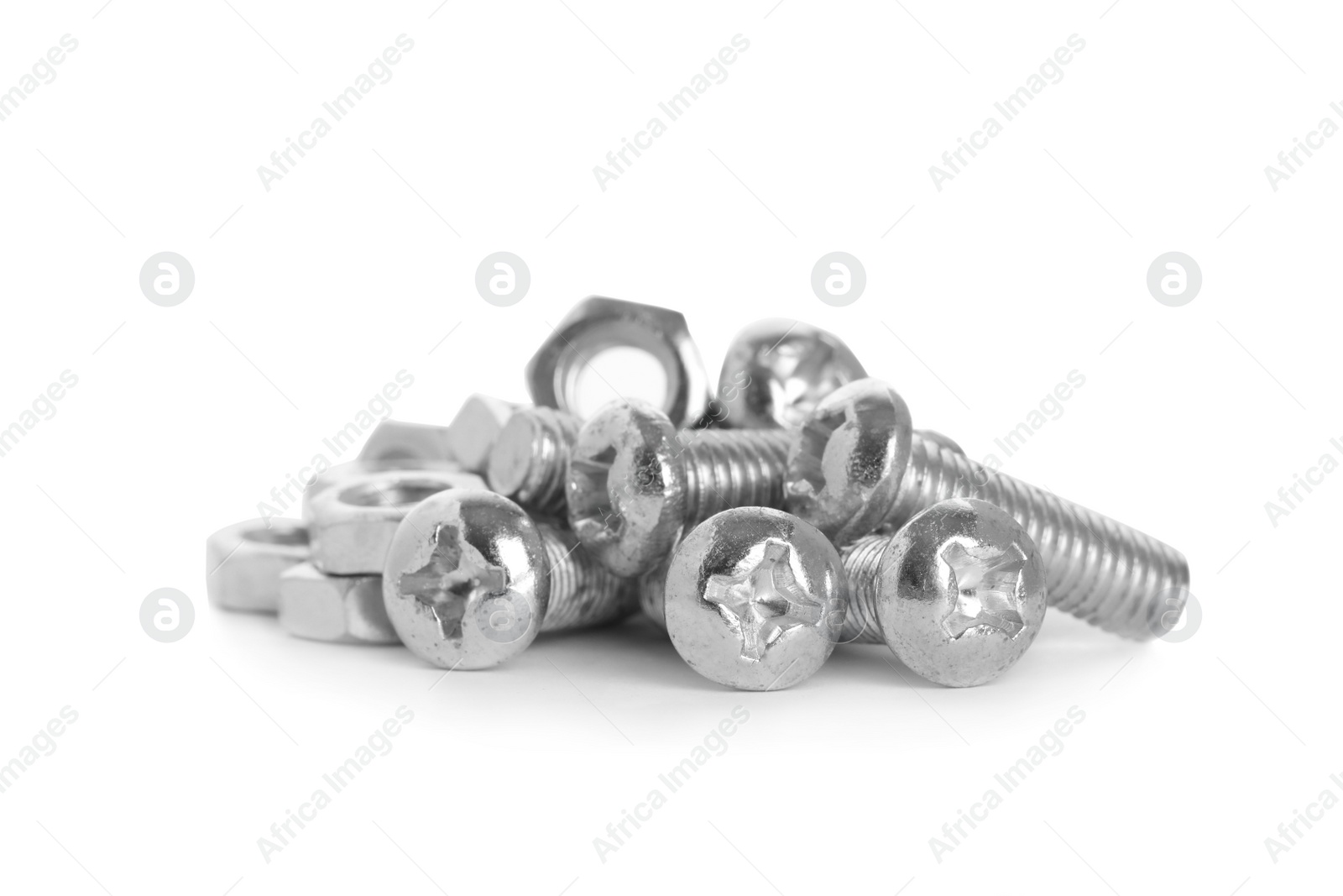 Photo of Many metal bolts and nuts on white background