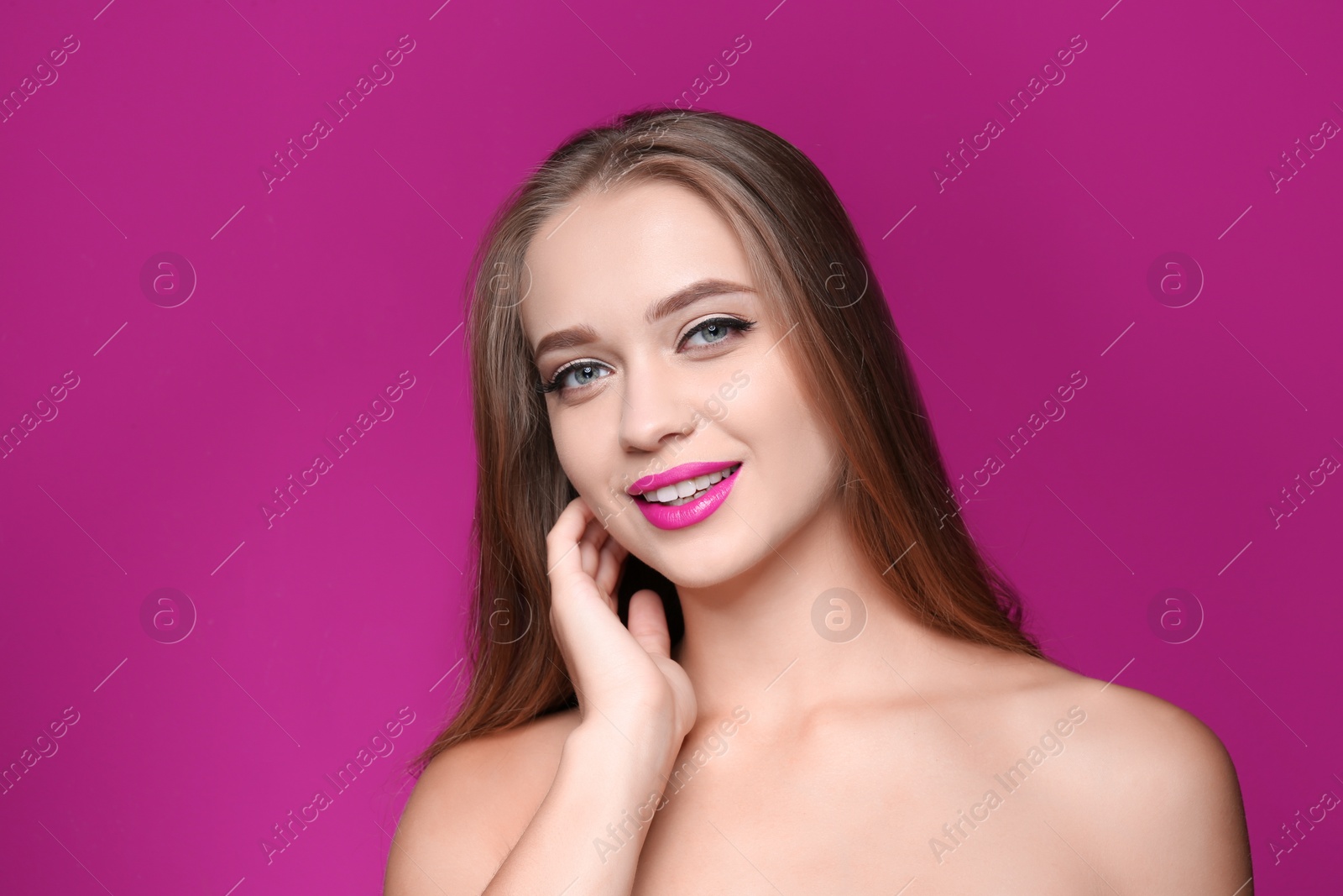 Photo of Beautiful young woman with perfect lips makeup on color background