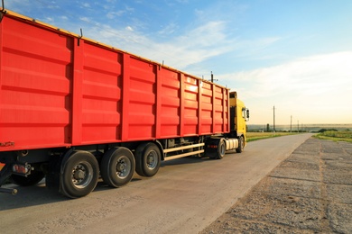 Photo of Modern truck on country road. Space for text