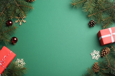 Photo of Frame made of Christmas decorations on green background, top view with space for text. Winter season