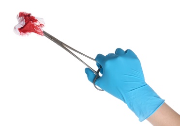 Photo of Doctor in medical glove holding clamp with tissue and blood on white background