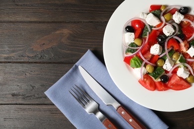 Photo of Plate with delicious salad on table, top view