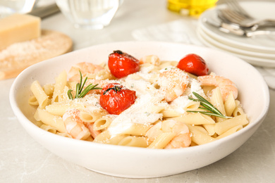 Delicious pasta with shrimps on light grey table