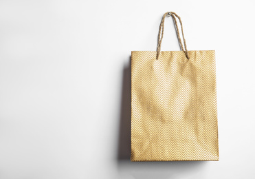 Photo of Gold shopping paper bag isolated on white