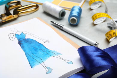 Drawing of dress on table, closeup. Designer's workplace