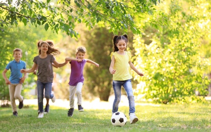 Photo of Cute little children playing with ball outdoors on sunny day