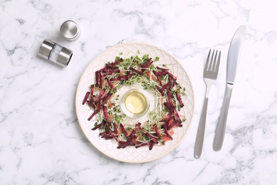 Photo of Delicious carrot salad served on white marble table, flat lay