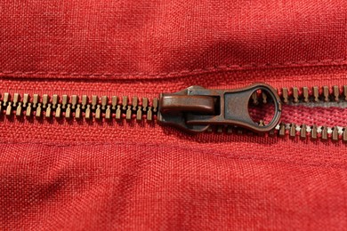 Photo of Red fabric with zipper as background, closeup view