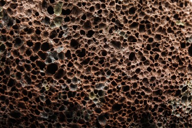 Photo of Texture of pumice stone as background, closeup