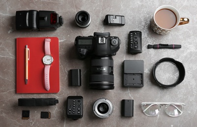 Flat lay composition with photographer's equipment and accessories on grey background