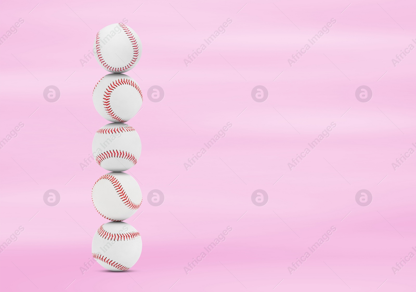 Image of Stack of baseball balls on pink background. Space for text