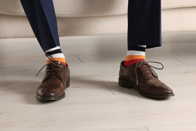 Man wearing stylish shoes and colorful socks indoors, closeup