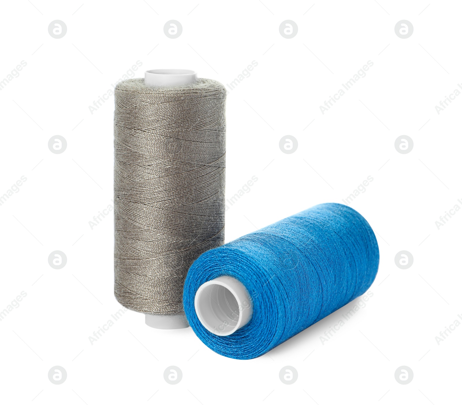 Photo of Different colorful sewing threads on white background