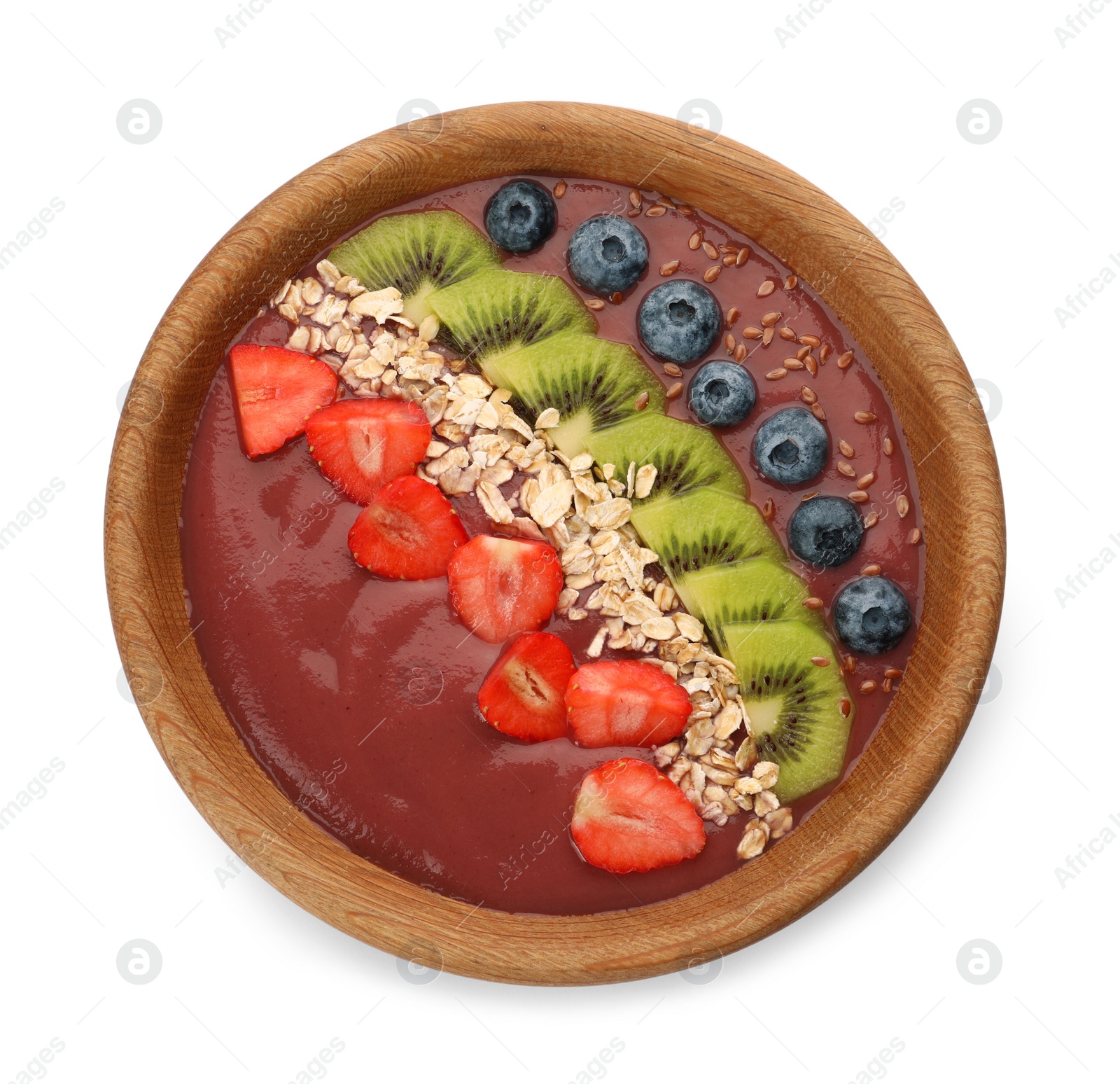 Photo of Bowl of delicious smoothie with fresh blueberries, strawberries, kiwi slices and oatmeal on white background, top view