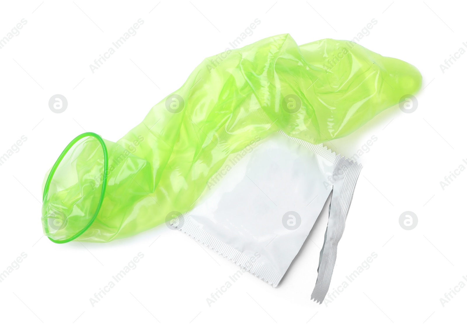 Image of Unrolled green condom and package on white background, top view. Safe sex