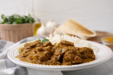 Photo of Delicious chicken curry with rice on table, closeup