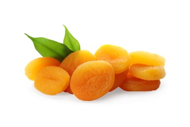 Photo of Pile of tasty dried apricots with leaves on white background