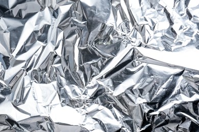 Crumpled silver foil as background, closeup view