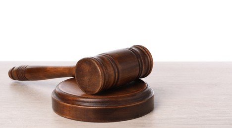 Photo of Wooden gavel on light table against white background. Space for text