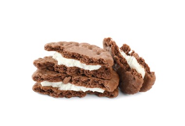 Broken tasty chocolate sandwich cookies with cream on white background