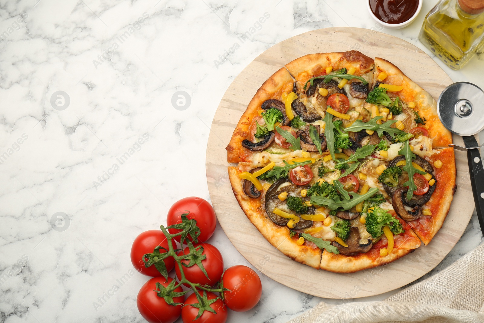 Photo of Delicious vegetarian pizza served on white marble table, flat lay. Space for text