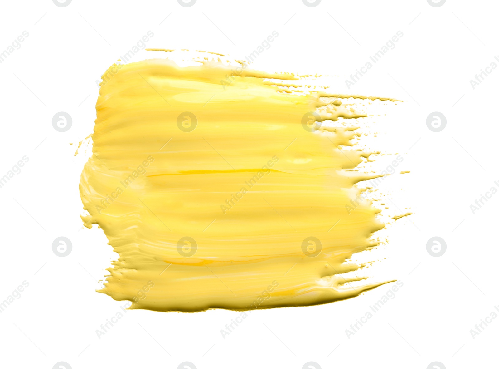 Photo of Abstract brushstroke of yellow paint isolated on white