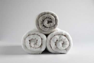 Fresh soft rolled towels on light background