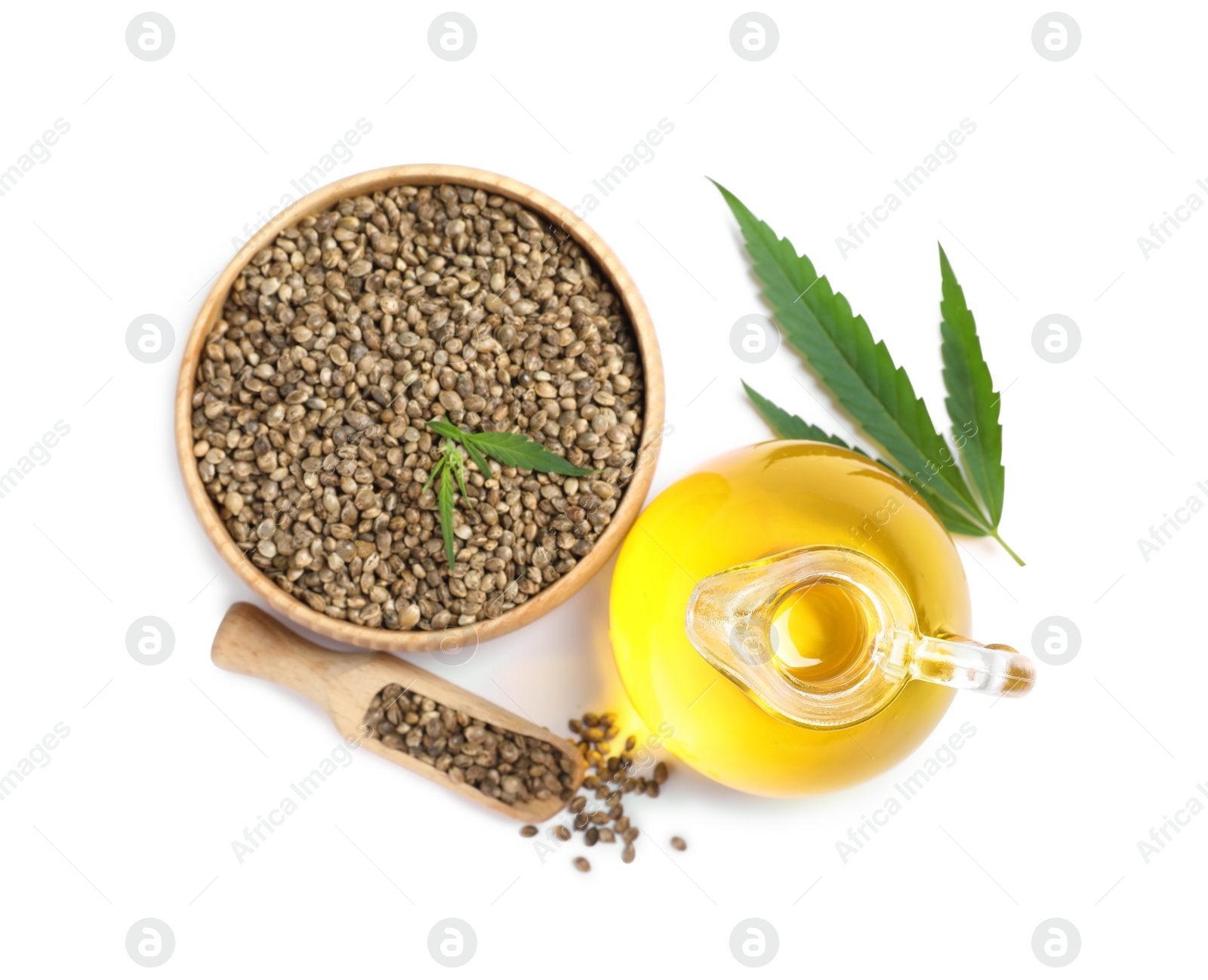 Photo of Hemp oil, fresh leaves and seeds on white background, top view