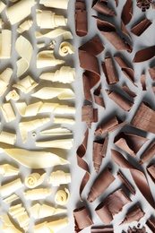 Photo of White and milk chocolate curls on gray background, top view