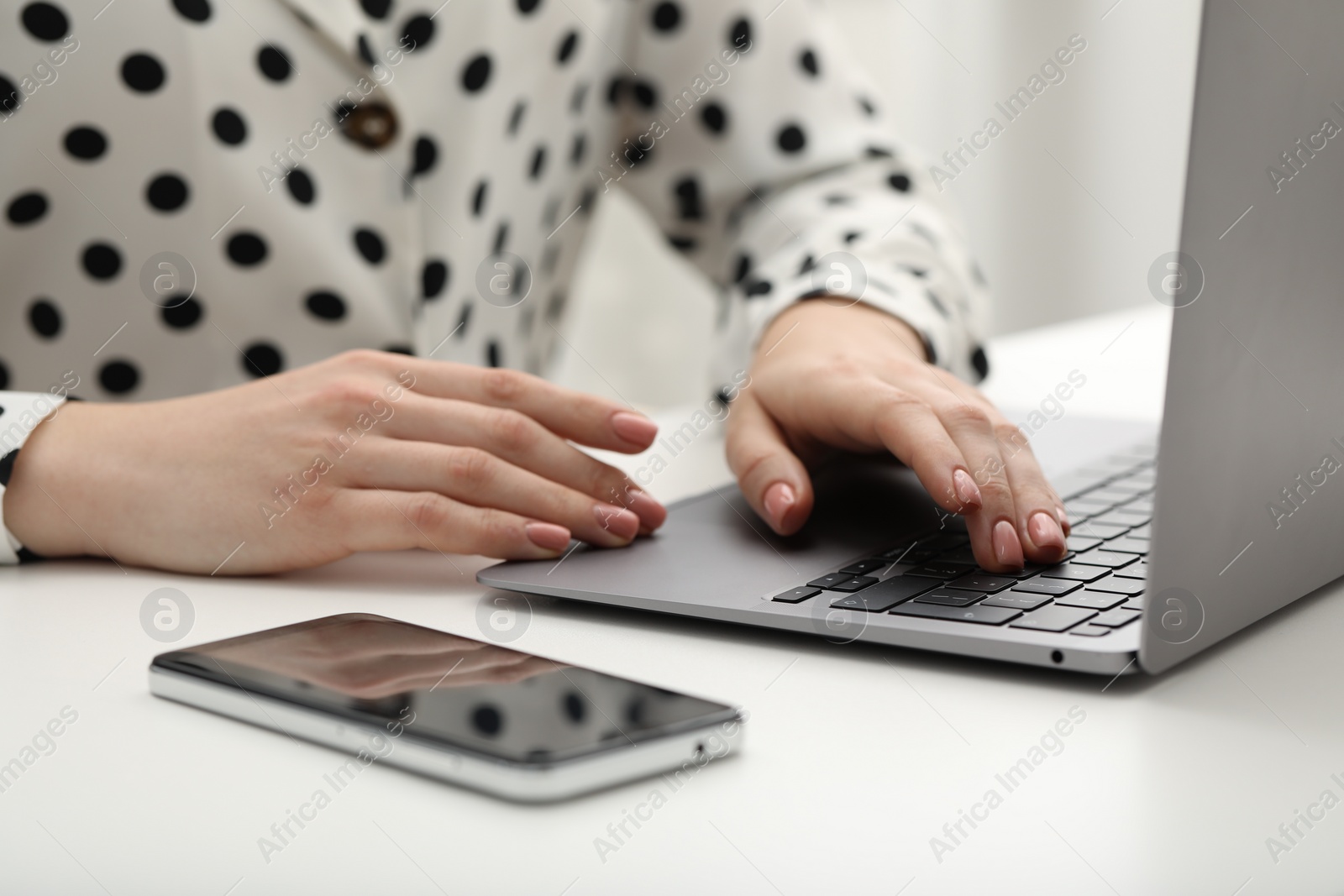 Photo of E-learning. Woman using laptop during online lesson at table indoors, closeup