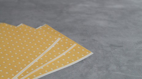 Photo of Pepper plasters on grey textured background, closeup. Space for text