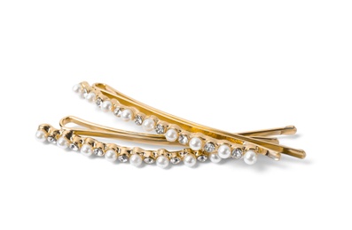 Photo of Beautiful gold hair pins with gems on white background