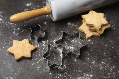 Tasty homemade Christmas cookies and cutters on table