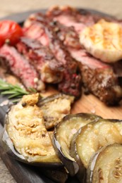 Photo of Delicious grilled eggplant and beef with spices on table, closeup