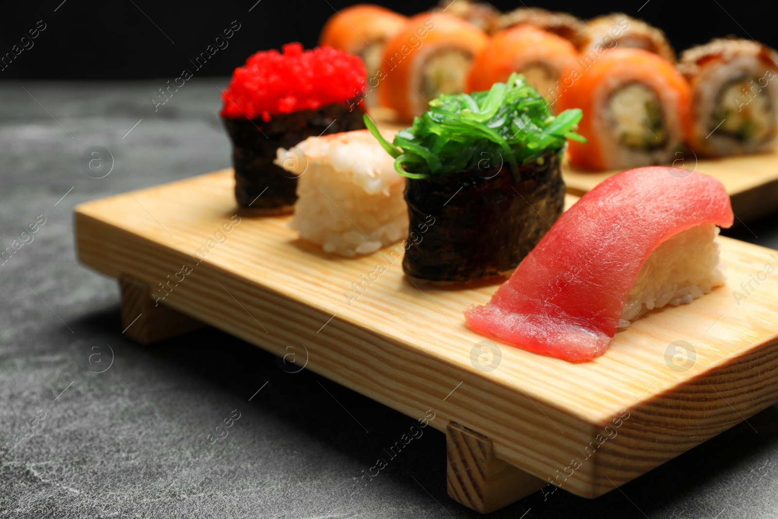 Photo of Set of delicious sushi on grey table