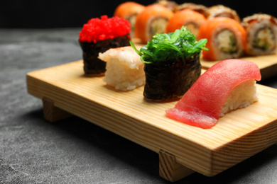 Set of delicious sushi on grey table